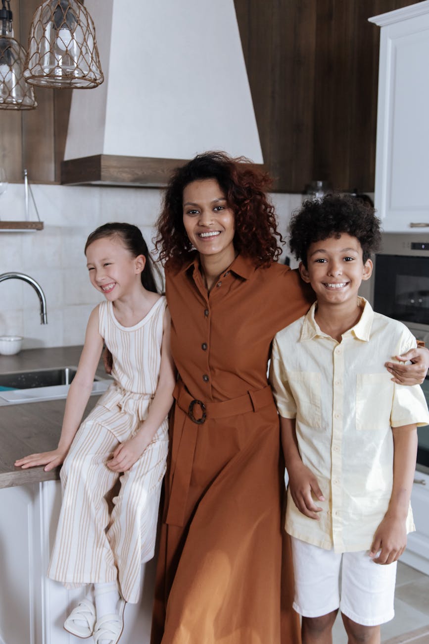 mom smiling with her son and daughter